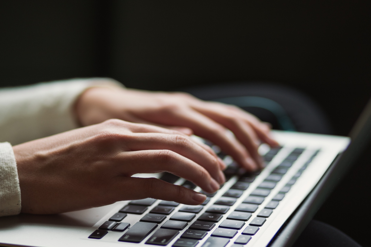 Woman Writing on a Laptop